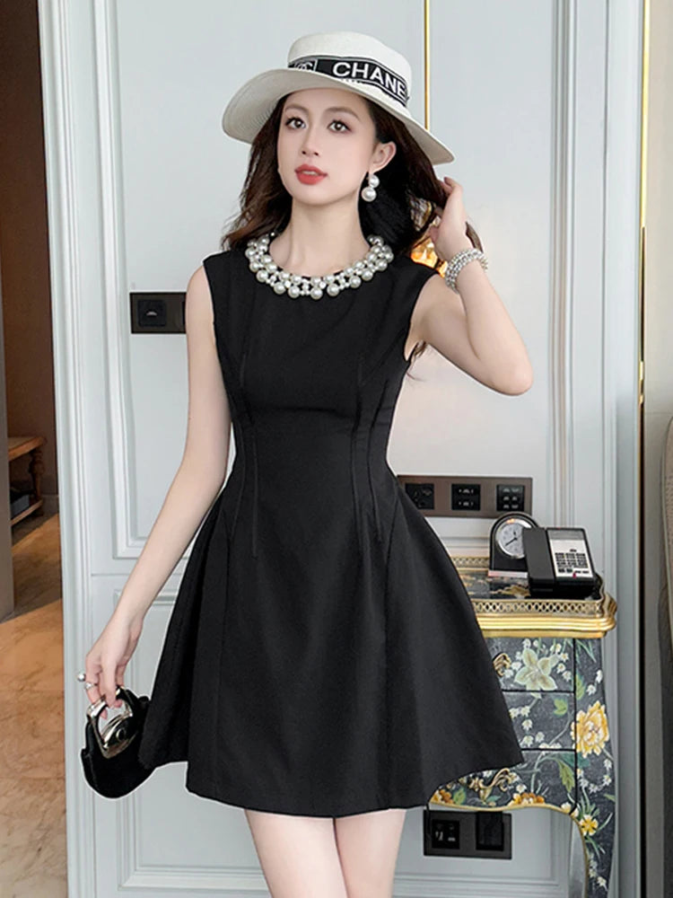 Black Dress With Pearl Necklace And Hat